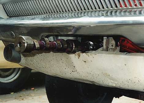 The cam can be slipped through the cut-out in the gravel pan