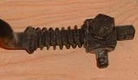 Adjustment "block & peg"  slides along the rod, clamps with the bolt